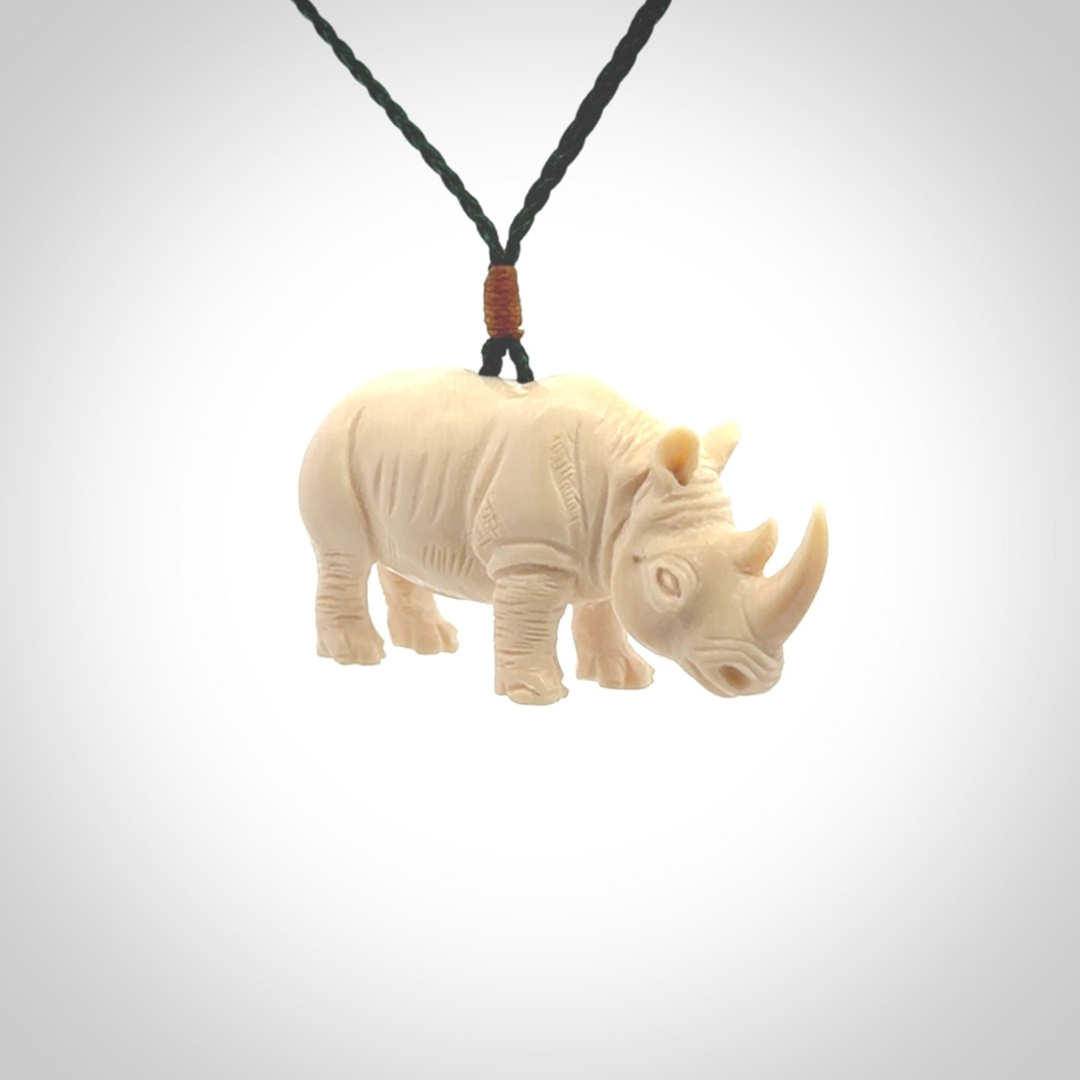 Hand carved Rhinoceros pendant. Carved from woolly mammoth tusk by NZ Pacific.