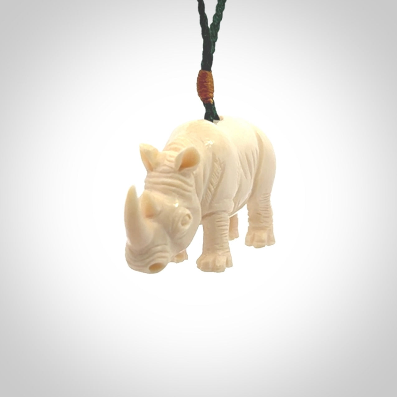 Hand carved Rhinoceros pendant. Carved from woolly mammoth tusk by NZ Pacific.