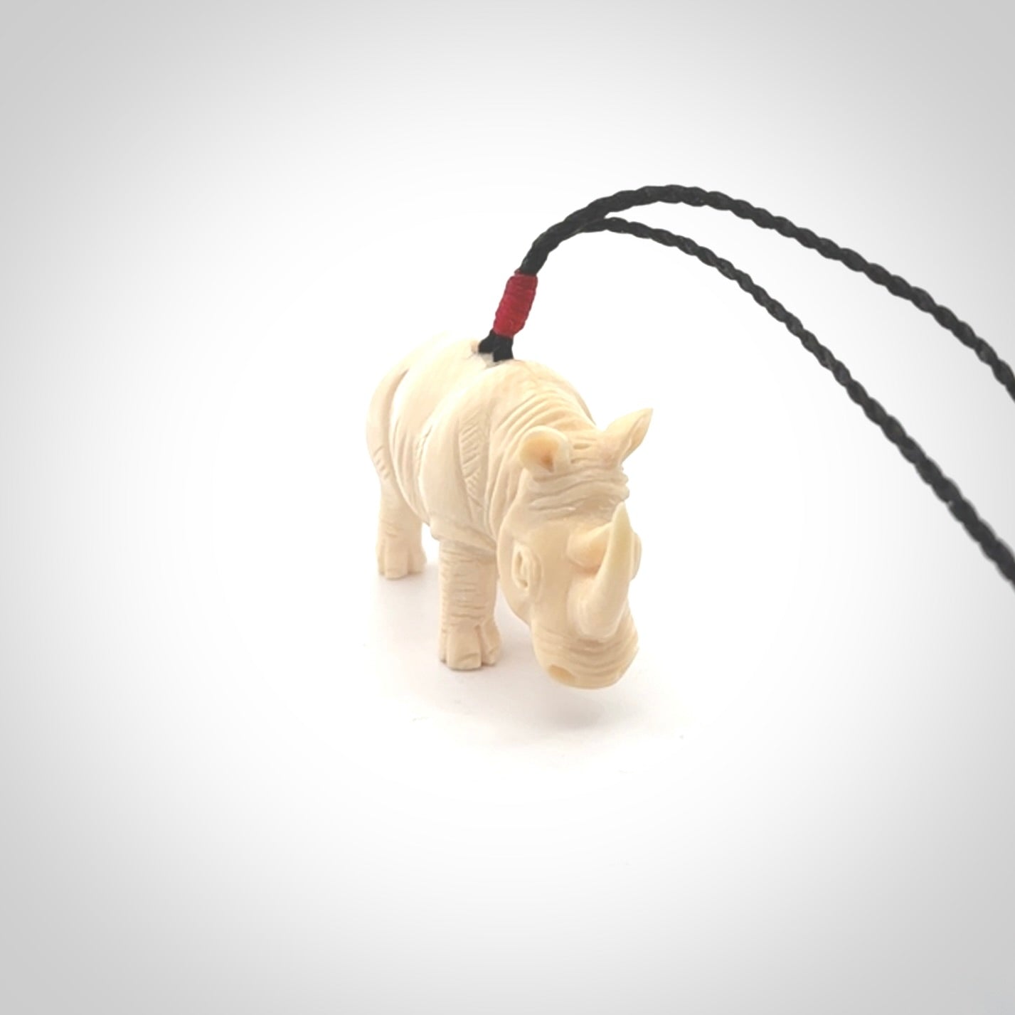 Hand carved Rhinoceros pendant. Carved from woolly mammoth tusk by NZ Pacific.