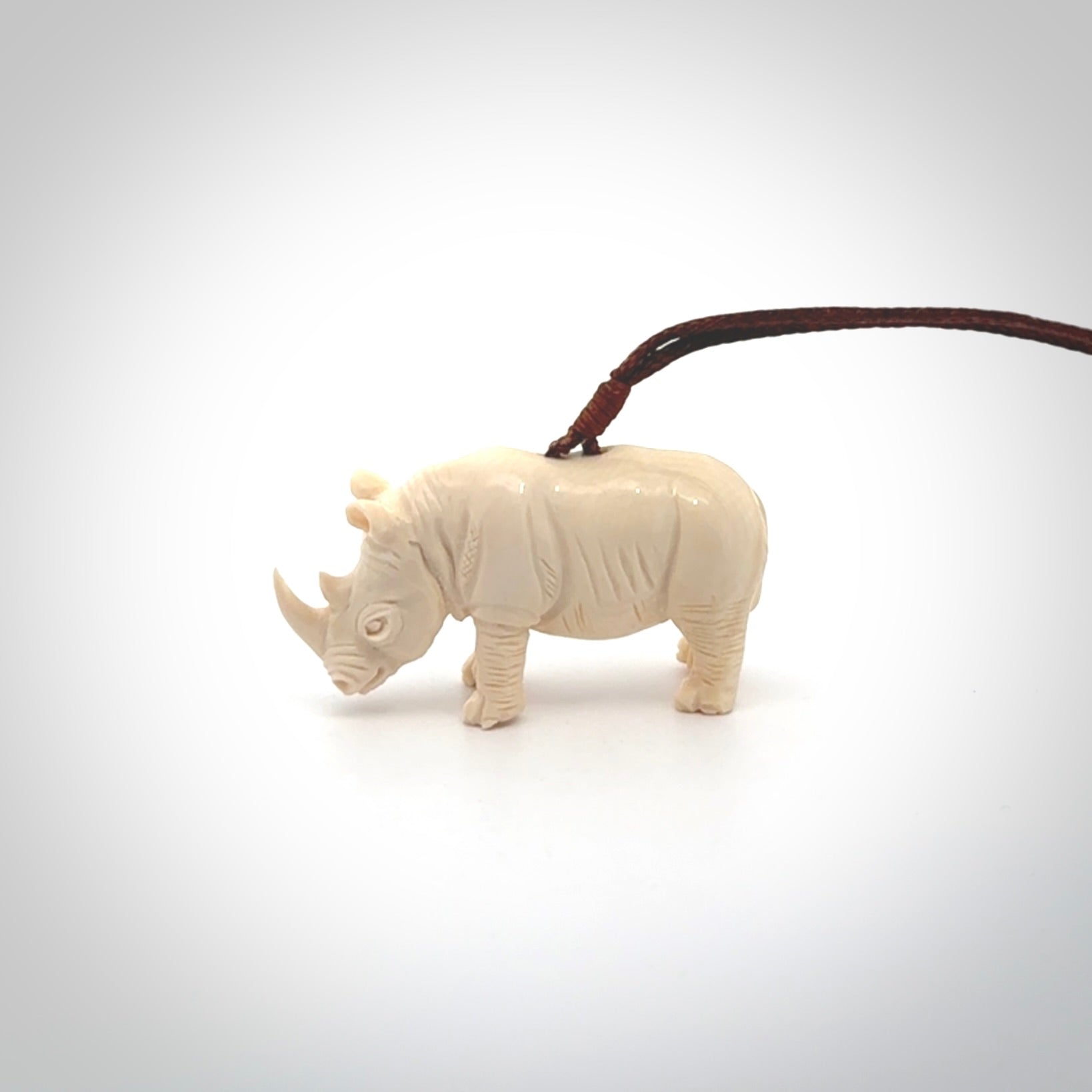 Hand carved Rhinoceros pendant. Carved from woolly mammoth tusk by NZ Pacific.