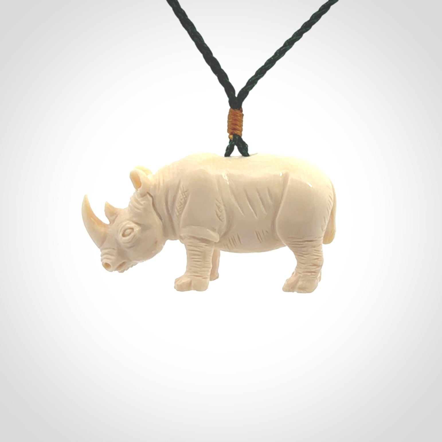 Hand carved Rhinoceros pendant. Carved from woolly mammoth tusk by NZ Pacific.