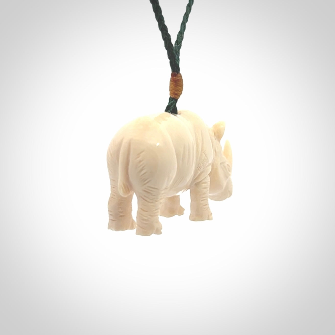 Hand carved Rhinoceros pendant. Carved from woolly mammoth tusk by NZ Pacific.