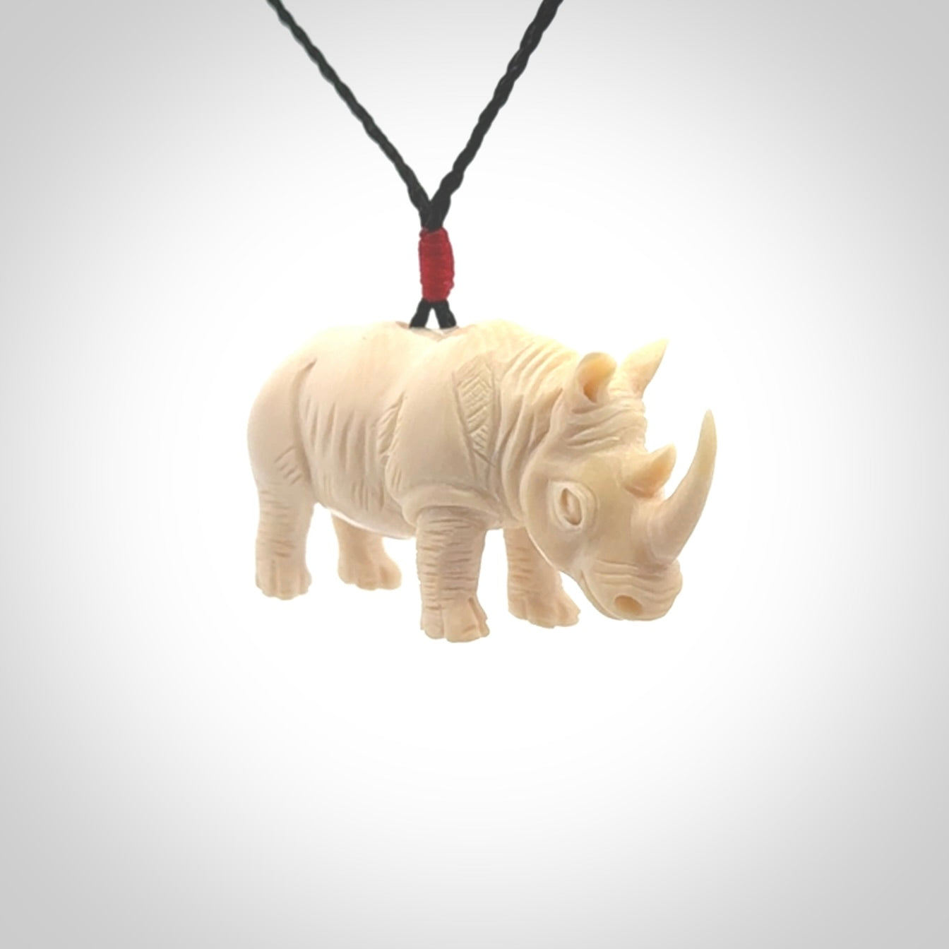 Hand carved Rhinoceros pendant. Carved from woolly mammoth tusk by NZ Pacific.
