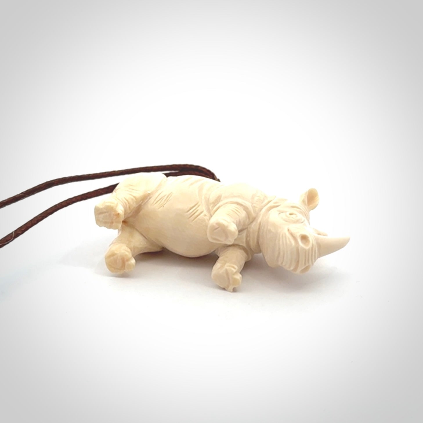 Hand carved Rhinoceros pendant. Carved from woolly mammoth tusk by NZ Pacific.