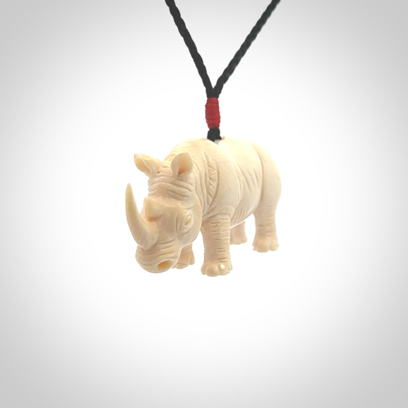 Hand carved Rhinoceros pendant. Carved from woolly mammoth tusk by NZ Pacific.