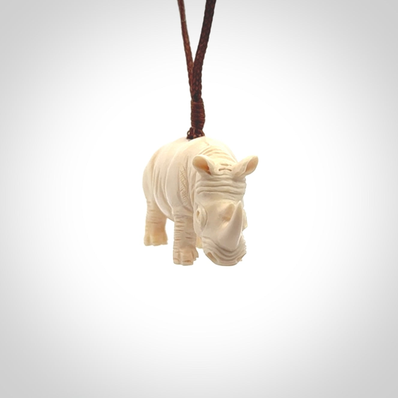 Hand carved Rhinoceros pendant. Carved from woolly mammoth tusk by NZ Pacific.