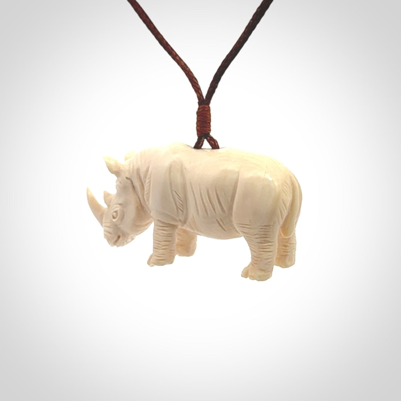 Hand carved Rhinoceros pendant. Carved from woolly mammoth tusk by NZ Pacific.