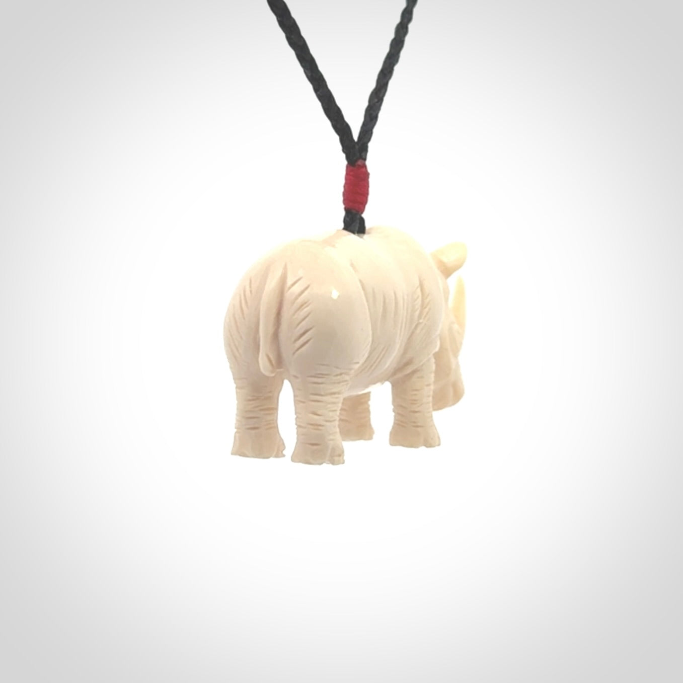 Hand carved Rhinoceros pendant. Carved from woolly mammoth tusk by NZ Pacific.