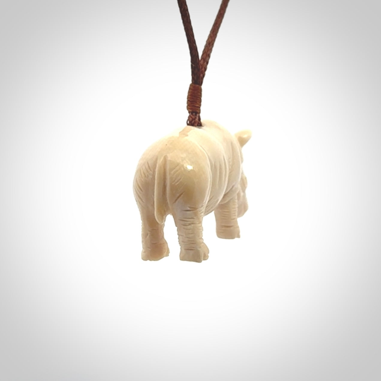 Hand carved Rhinoceros pendant. Carved from woolly mammoth tusk by NZ Pacific.