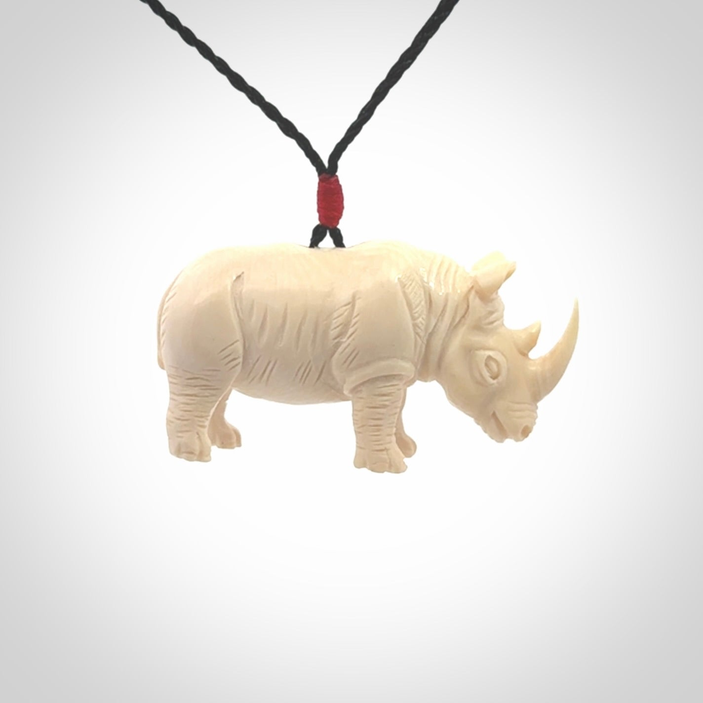 Hand carved Rhinoceros pendant. Carved from woolly mammoth tusk by NZ Pacific.