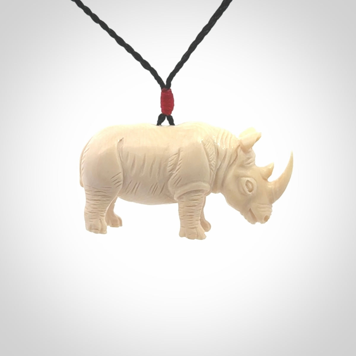 Hand carved Rhinoceros pendant. Carved from woolly mammoth tusk by NZ Pacific.