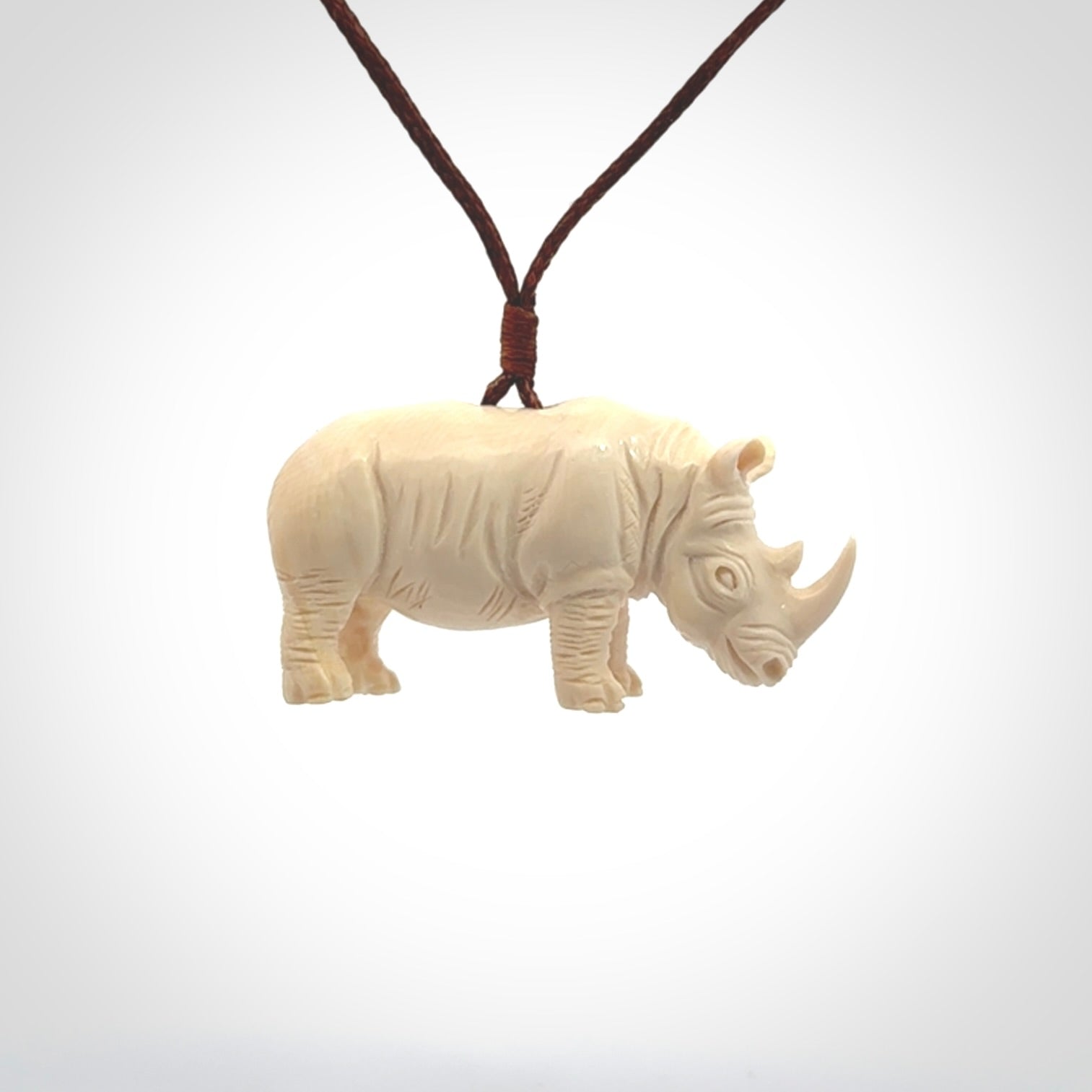 Hand carved Rhinoceros pendant. Carved from woolly mammoth tusk by NZ Pacific.