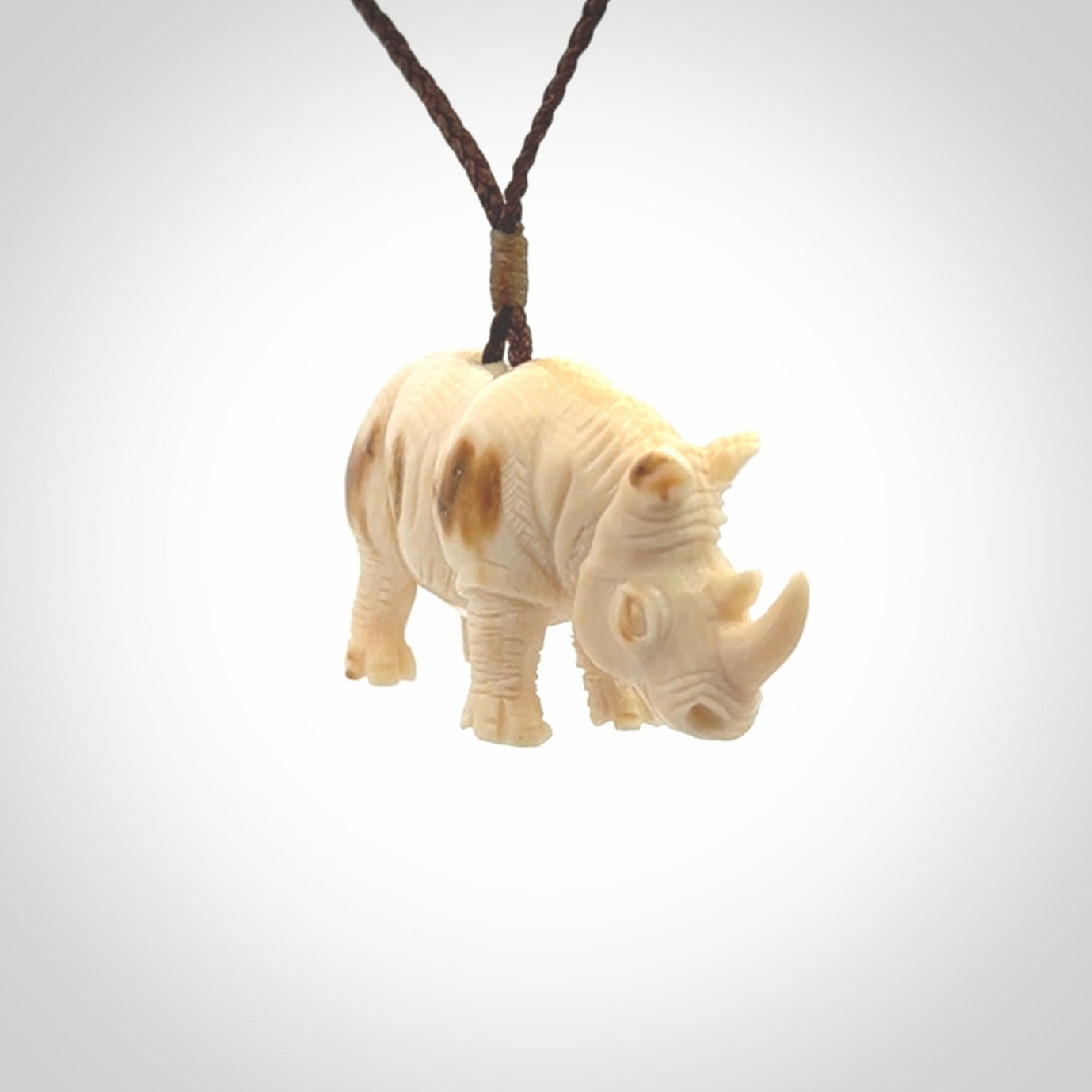 Hand carved Rhinoceros pendant. Carved from woolly mammoth tusk by NZ Pacific.
