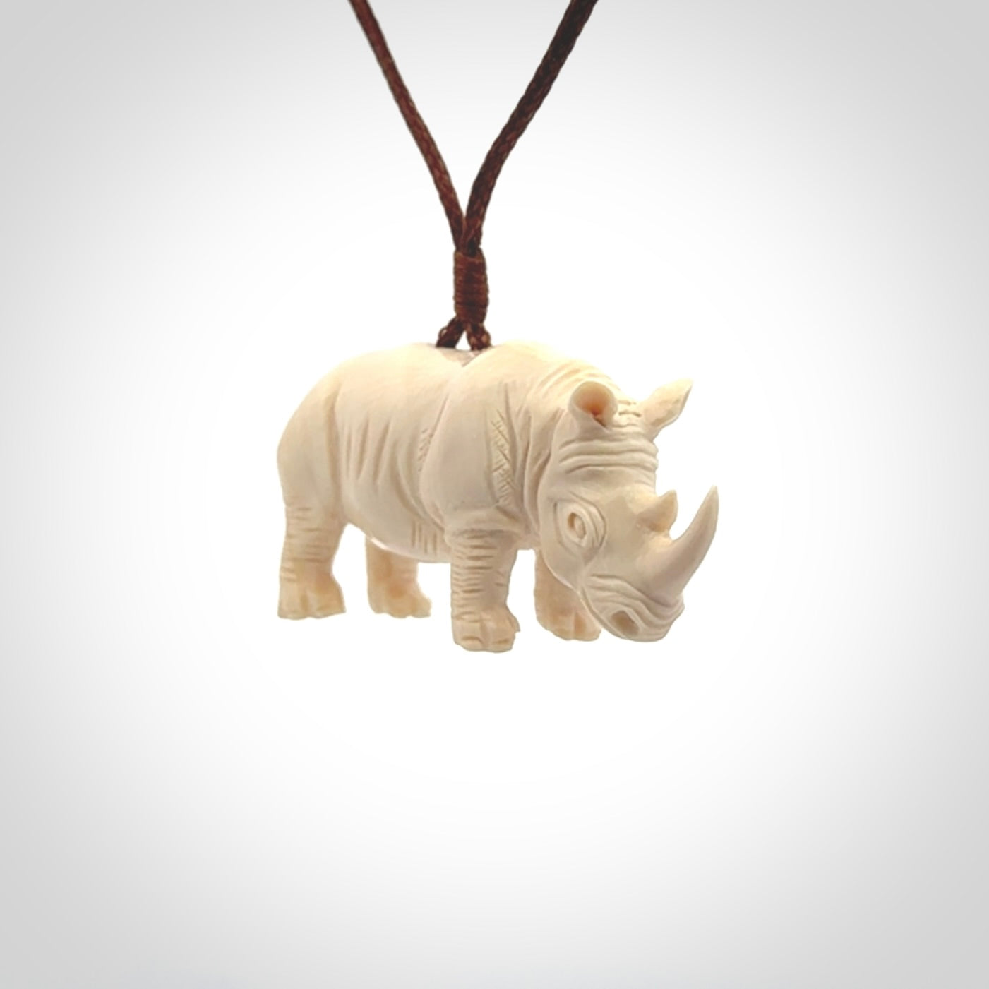 Hand carved Rhinoceros pendant. Carved from woolly mammoth tusk by NZ Pacific.