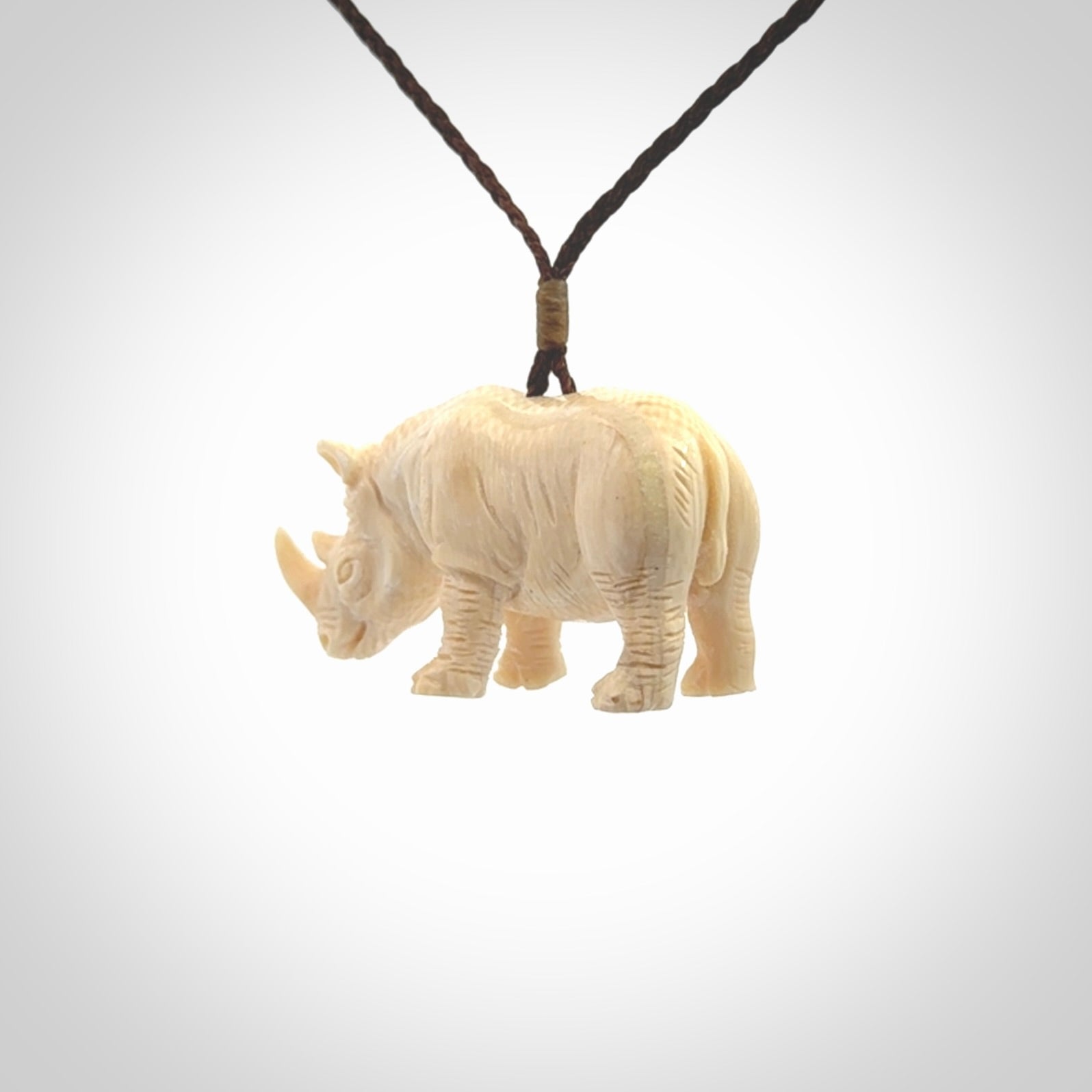 Hand carved Rhinoceros pendant. Carved from woolly mammoth tusk by NZ Pacific.