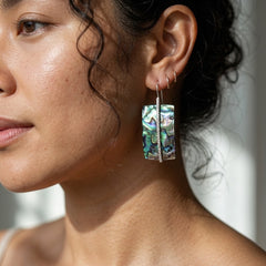 Woman wearing paua shell earring