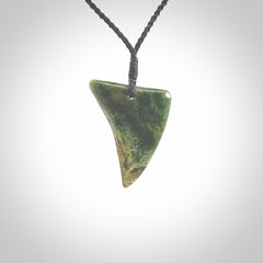 This is a lovely New Zealand Jade, pounamu drop pendant. Hand carved for us by Ric Moor. It is bound with an adjustable black coloured cord which is length adjustable. Free worldwide shipping.