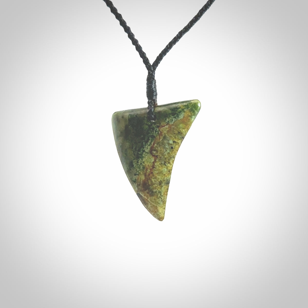 This is a lovely New Zealand Jade, pounamu drop pendant. Hand carved for us by Ric Moor. It is bound with an adjustable black coloured cord which is length adjustable. Free worldwide shipping.