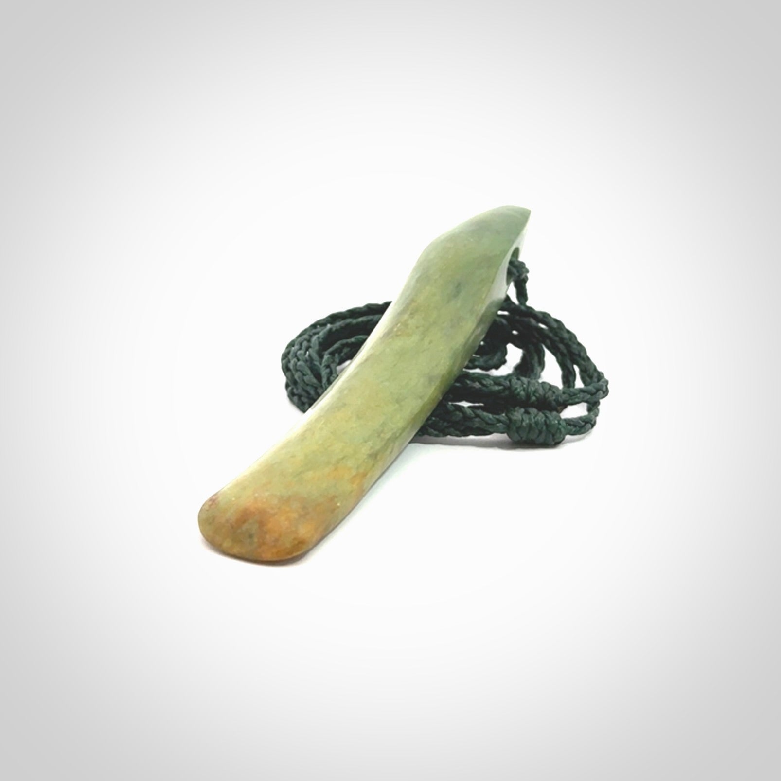 This is a lovely, large, New Zealand Flower Jade, pounamu drop pendant. Hand carved for us by Ric Moor. It is bound with an adjustable manuka green coloured cord which is length adjustable.