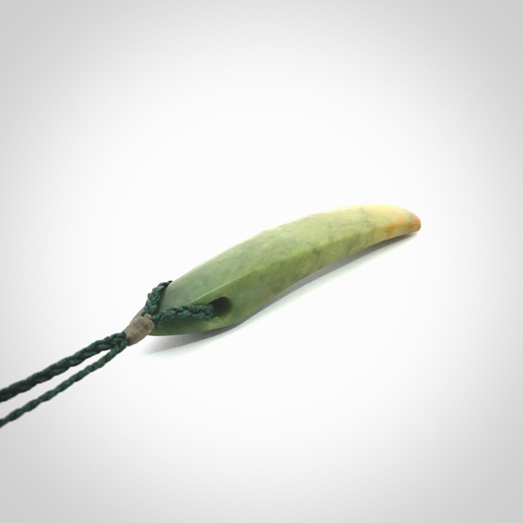 This is a lovely, large, New Zealand Flower Jade, pounamu drop pendant. Hand carved for us by Ric Moor. It is bound with an adjustable manuka green coloured cord which is length adjustable.