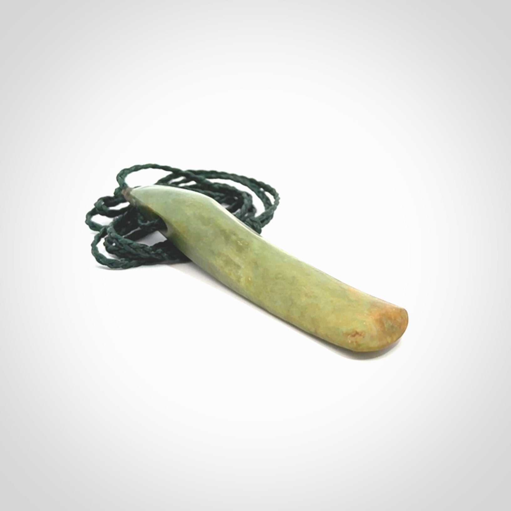 This is a lovely, large, New Zealand Flower Jade, pounamu drop pendant. Hand carved for us by Ric Moor. It is bound with an adjustable manuka green coloured cord which is length adjustable.