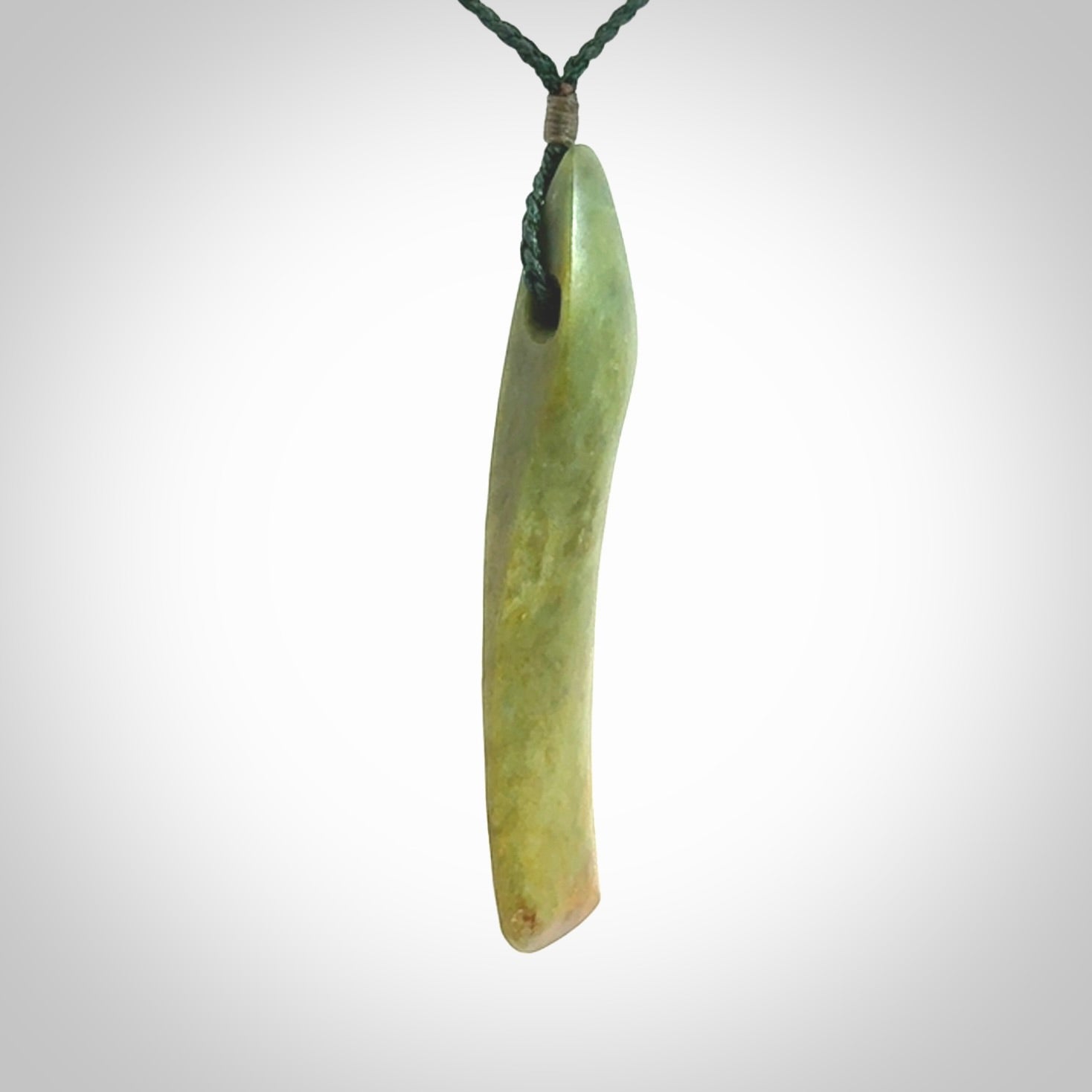 This is a lovely, large, New Zealand Flower Jade, pounamu drop pendant. Hand carved for us by Ric Moor. It is bound with an adjustable manuka green coloured cord which is length adjustable.