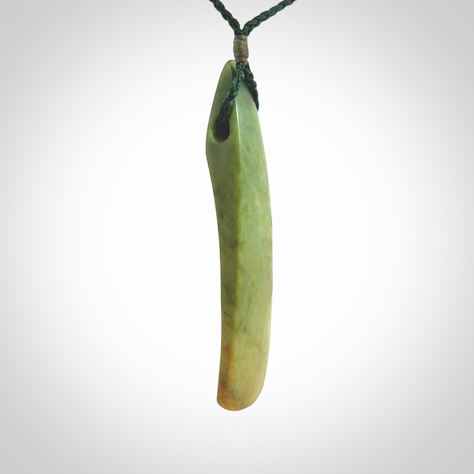 This is a lovely, large, New Zealand Flower Jade, pounamu drop pendant. Hand carved for us by Ric Moor. It is bound with an adjustable manuka green coloured cord which is length adjustable.