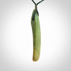 This is a lovely, large, New Zealand Flower Jade, pounamu drop pendant. Hand carved for us by Ric Moor. It is bound with an adjustable manuka green coloured cord which is length adjustable.