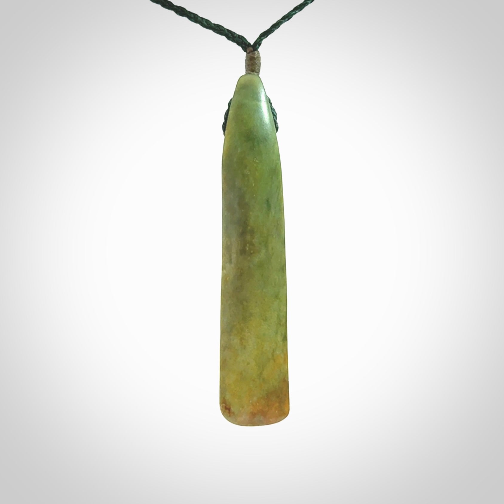 This is a lovely, large, New Zealand Flower Jade, pounamu drop pendant. Hand carved for us by Ric Moor. It is bound with an adjustable manuka green coloured cord which is length adjustable.