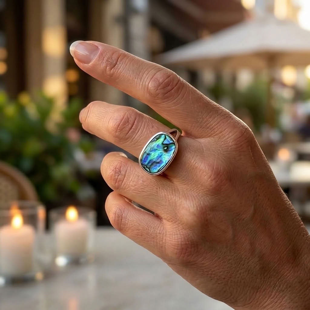 Hand wearing paua and silver ring