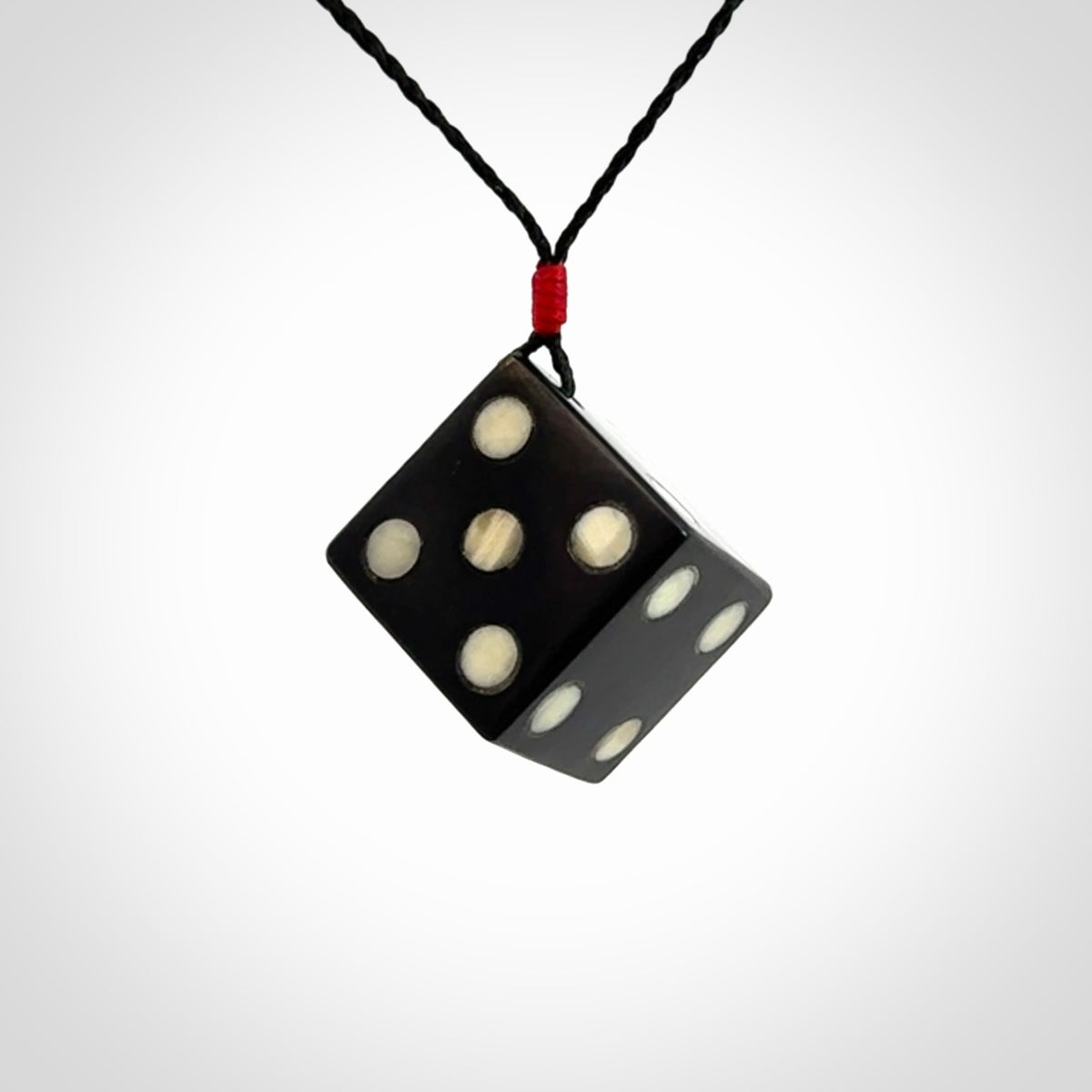 Hand carved black jade and bone dice pendant