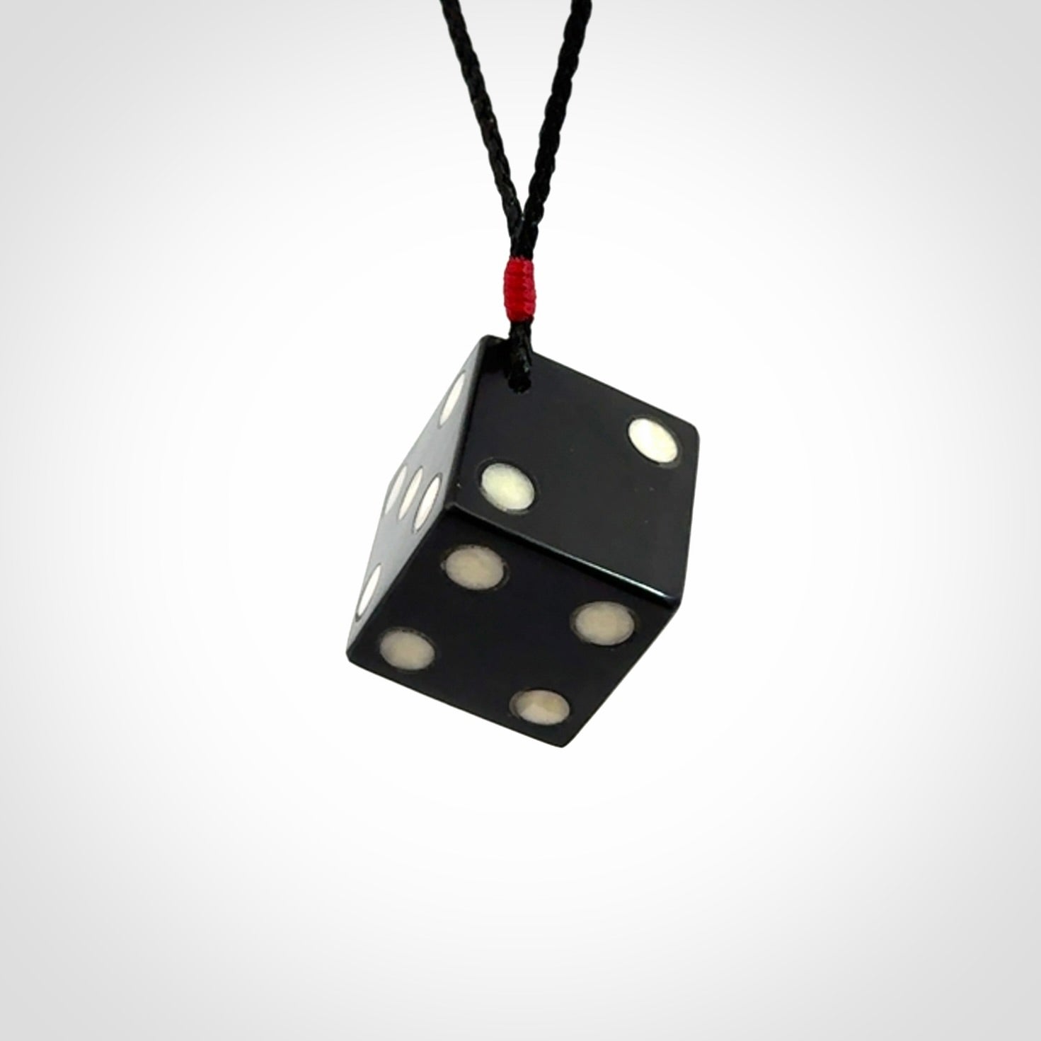 Hand carved black jade and bone dice pendant