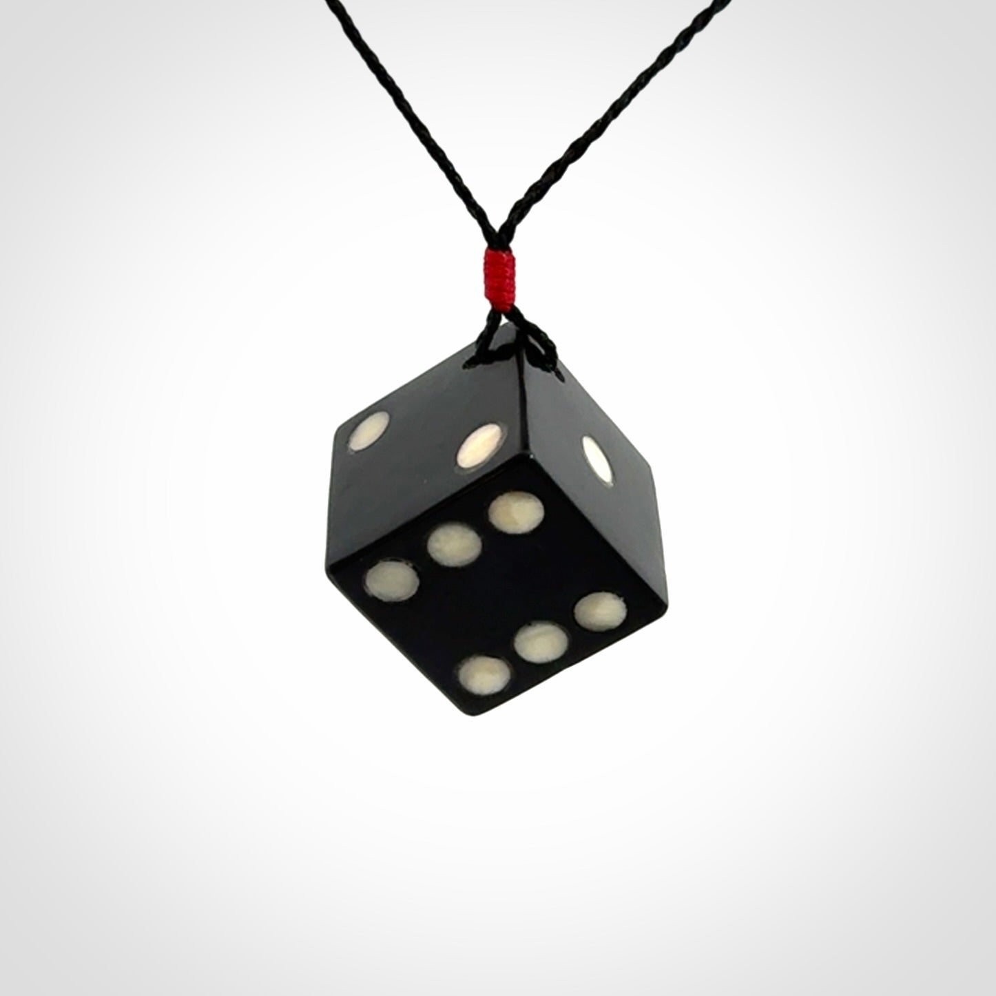 Hand carved black jade and bone dice pendant