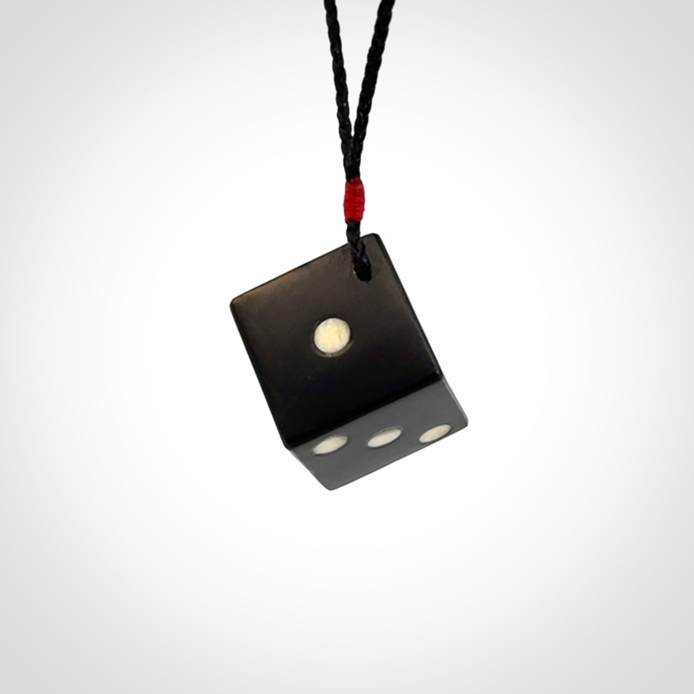 Hand carved black jade and bone dice pendant