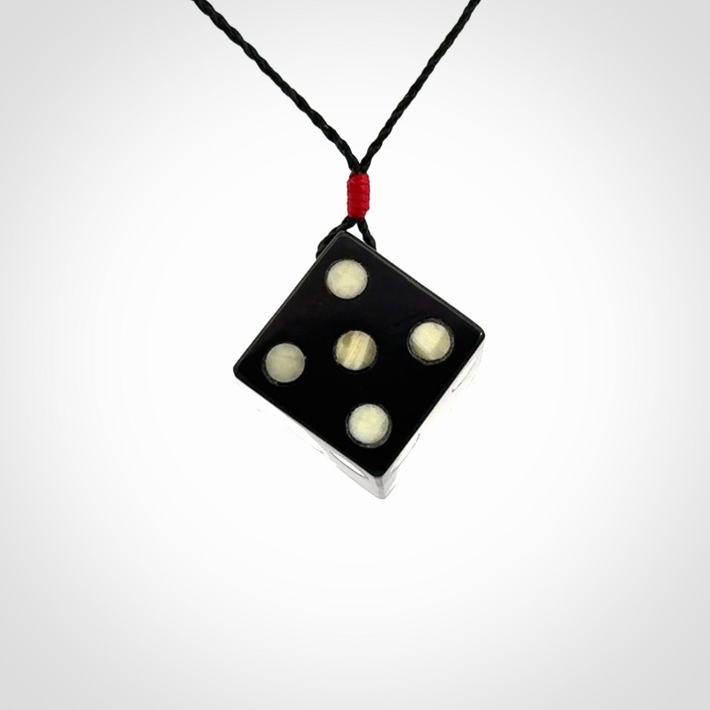 Hand carved black jade and bone dice pendant