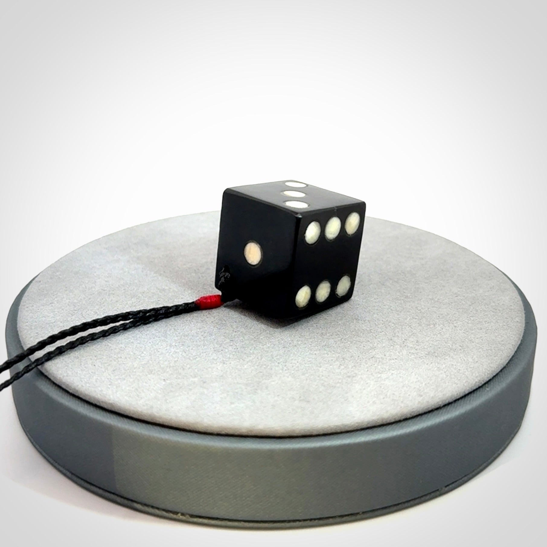 Hand carved black jade and bone dice pendant