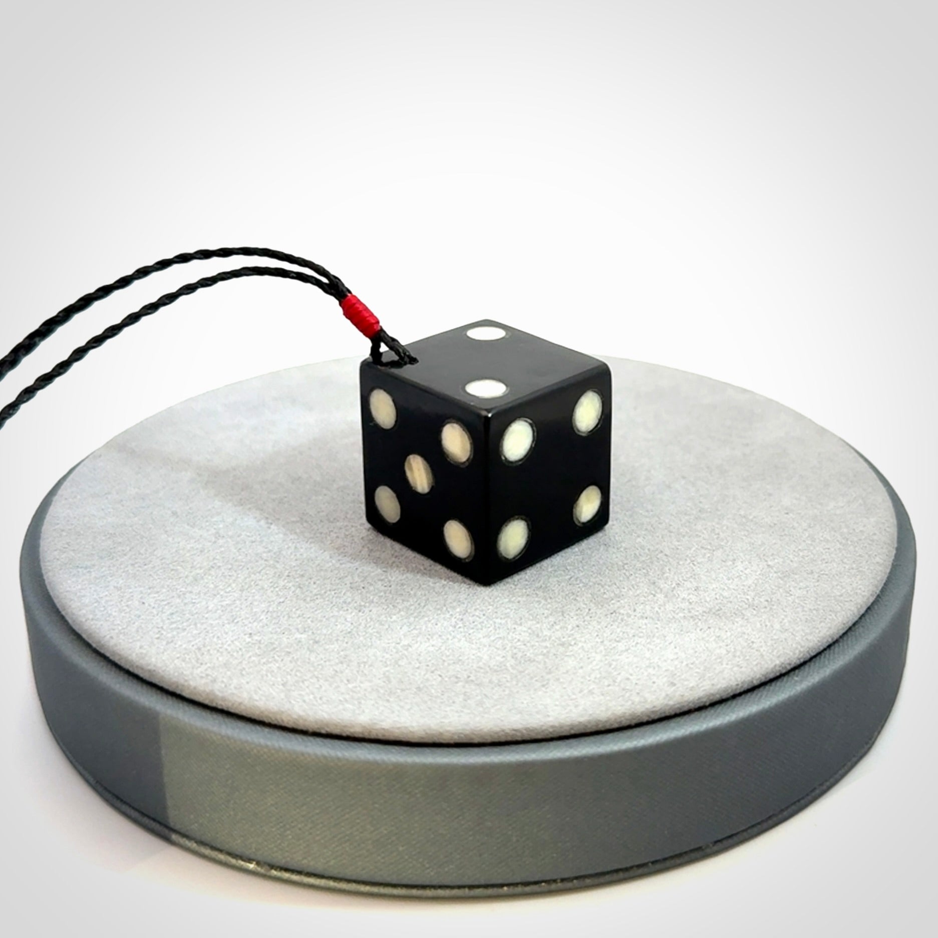 Hand carved black jade and bone dice pendant