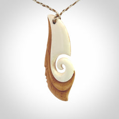A hand carved bone contemporary, intricate pendant. The cord is a 4 strand, 3 plait in Ice White and Tan and is an adjustable length. A large sized hand made contemporary necklace by New Zealand artist Kerry Thompson. Kerry has stained parts of the bone which really add to the dimension of this pendant. One of work of art to wear.