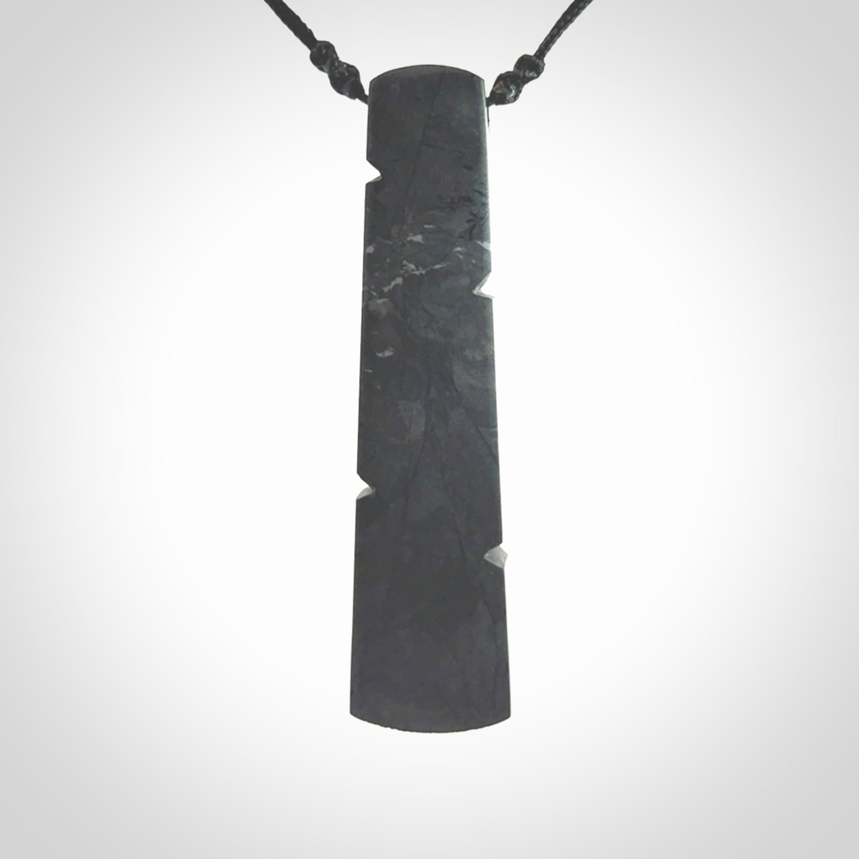 Hand made large New Zealand argillite toki pendant. Hand carved in New Zealand by Rueben Tipene. Hand made jewellery. Unique large argillite Toki with adjustable cord. Free shipping worldwide.