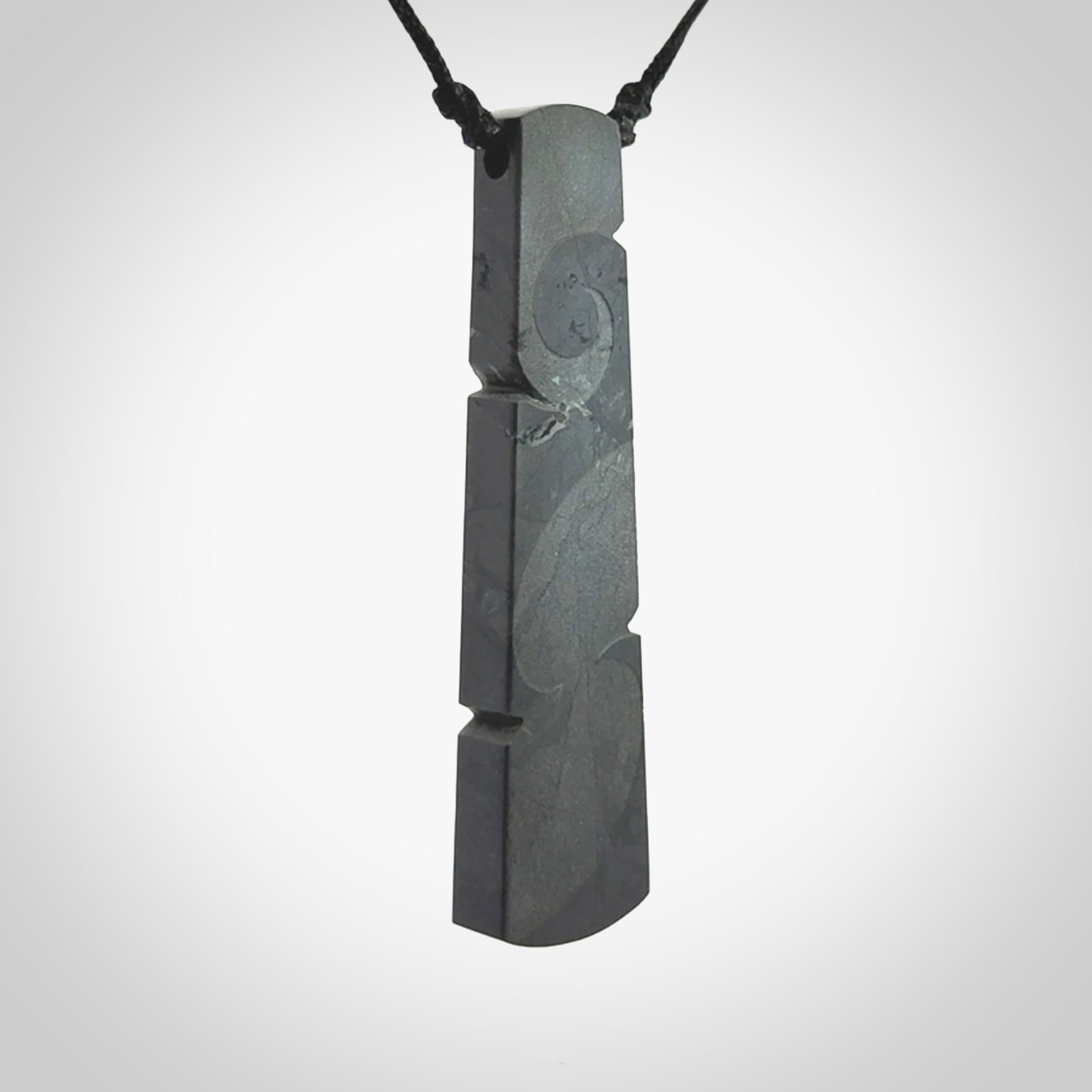 Hand made large New Zealand argillite toki pendant. Hand carved in New Zealand by Rueben Tipene. Hand made jewellery. Unique large argillite Toki with adjustable cord. Free shipping worldwide.