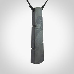 Hand made large New Zealand argillite toki pendant. Hand carved in New Zealand by Rueben Tipene. Hand made jewellery. Unique large argillite Toki with adjustable cord. Free shipping worldwide.