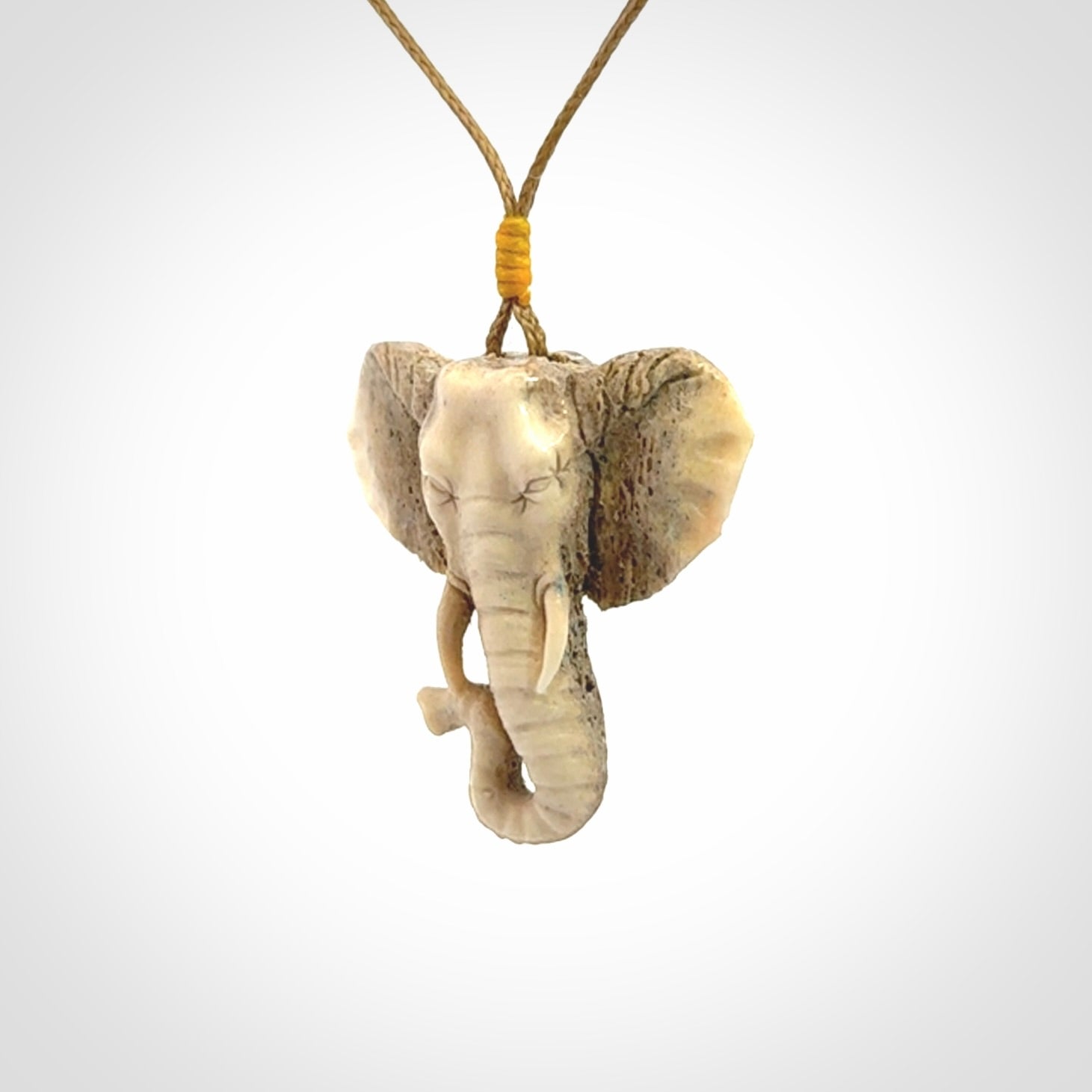 These are hand made elephant pendants, carved in a Deer Antler. The cord is length adjustable. Provided in a woven kete pouch and delivered with express courier.