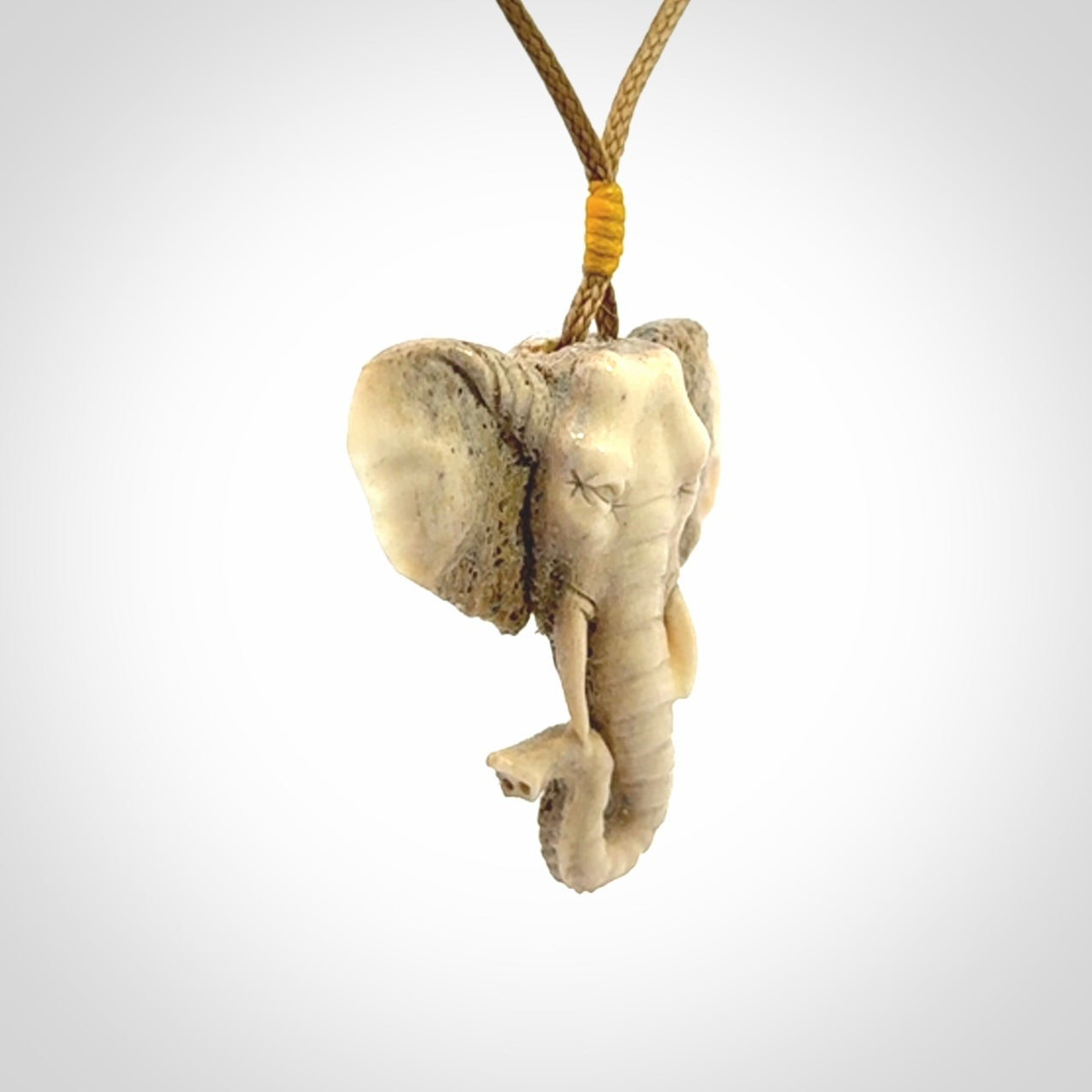 These are hand made elephant pendants, carved in a Deer Antler. The cord is length adjustable. Provided in a woven kete pouch and delivered with express courier.