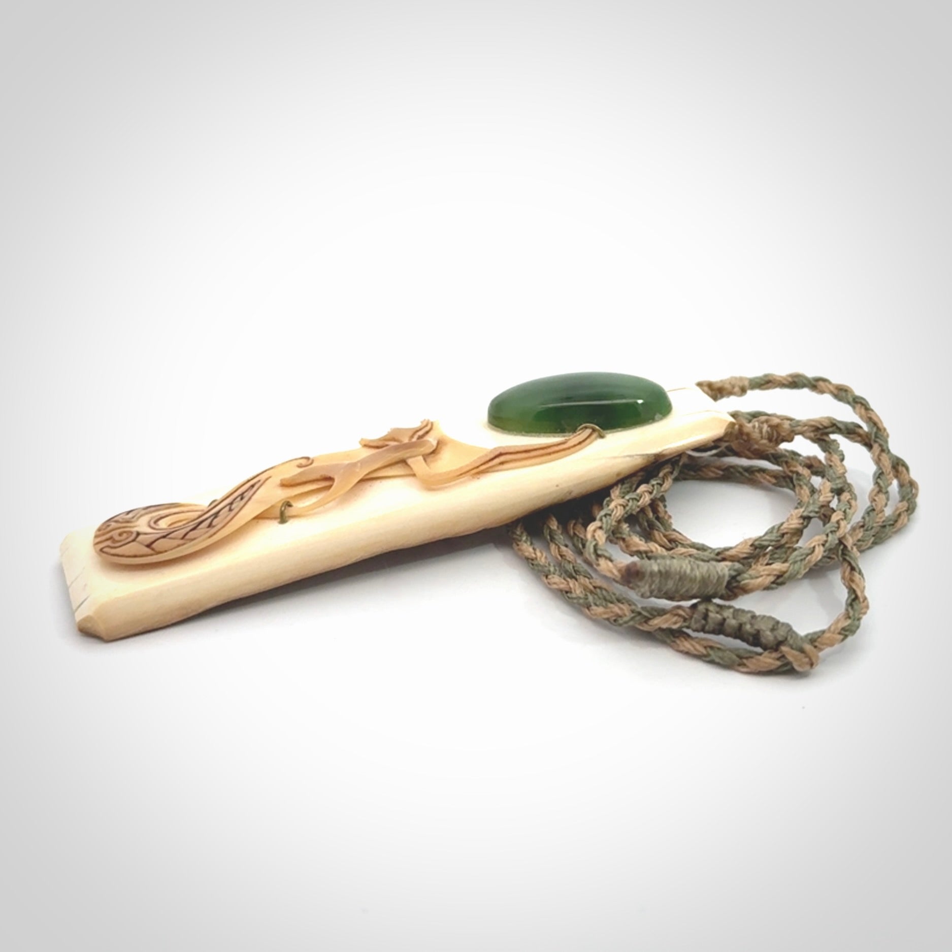 A beautiful, large toki with manaia pendant handmade from woolly mammoth tusk with Jade insert.