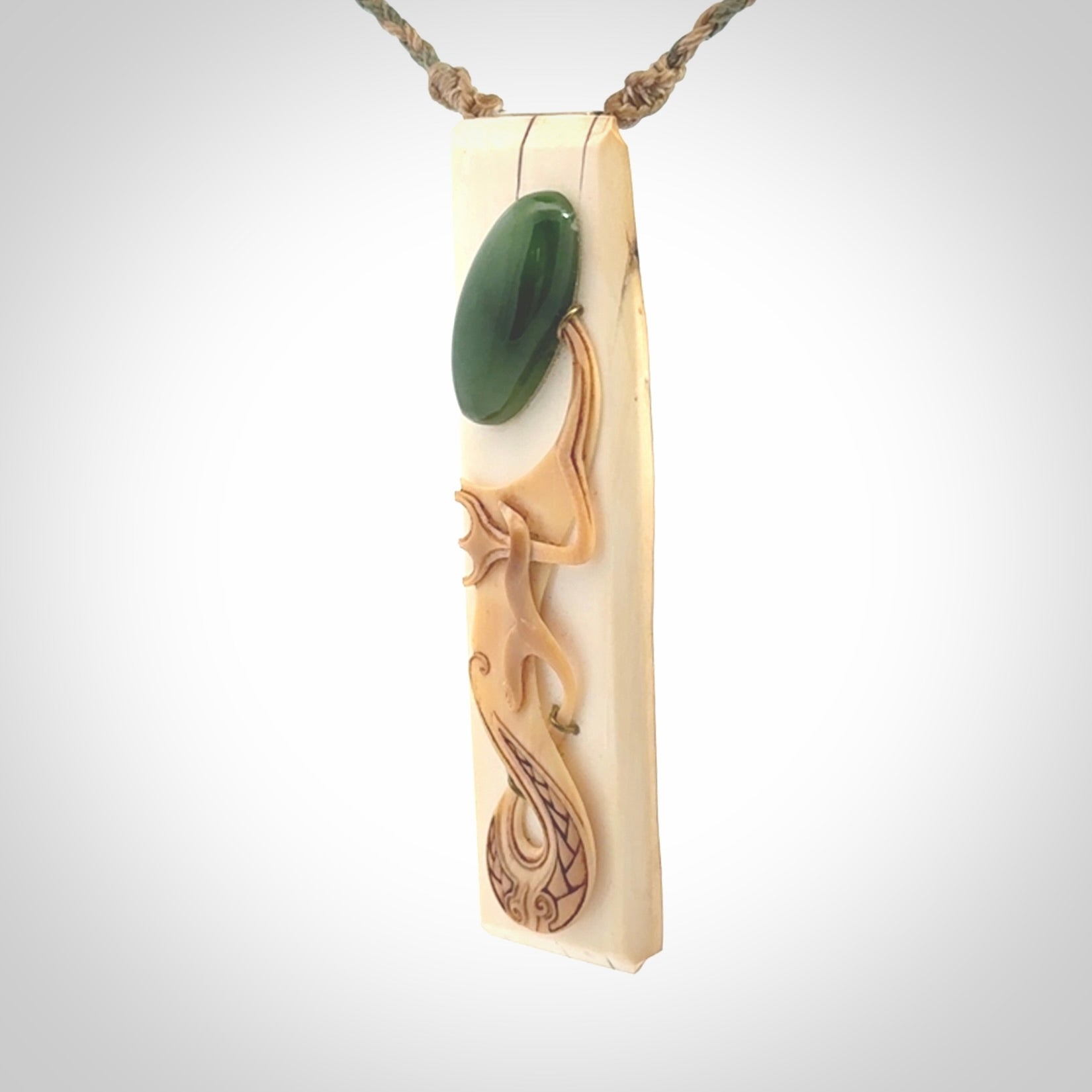 A beautiful, large toki with manaia pendant handmade from woolly mammoth tusk with Jade insert.