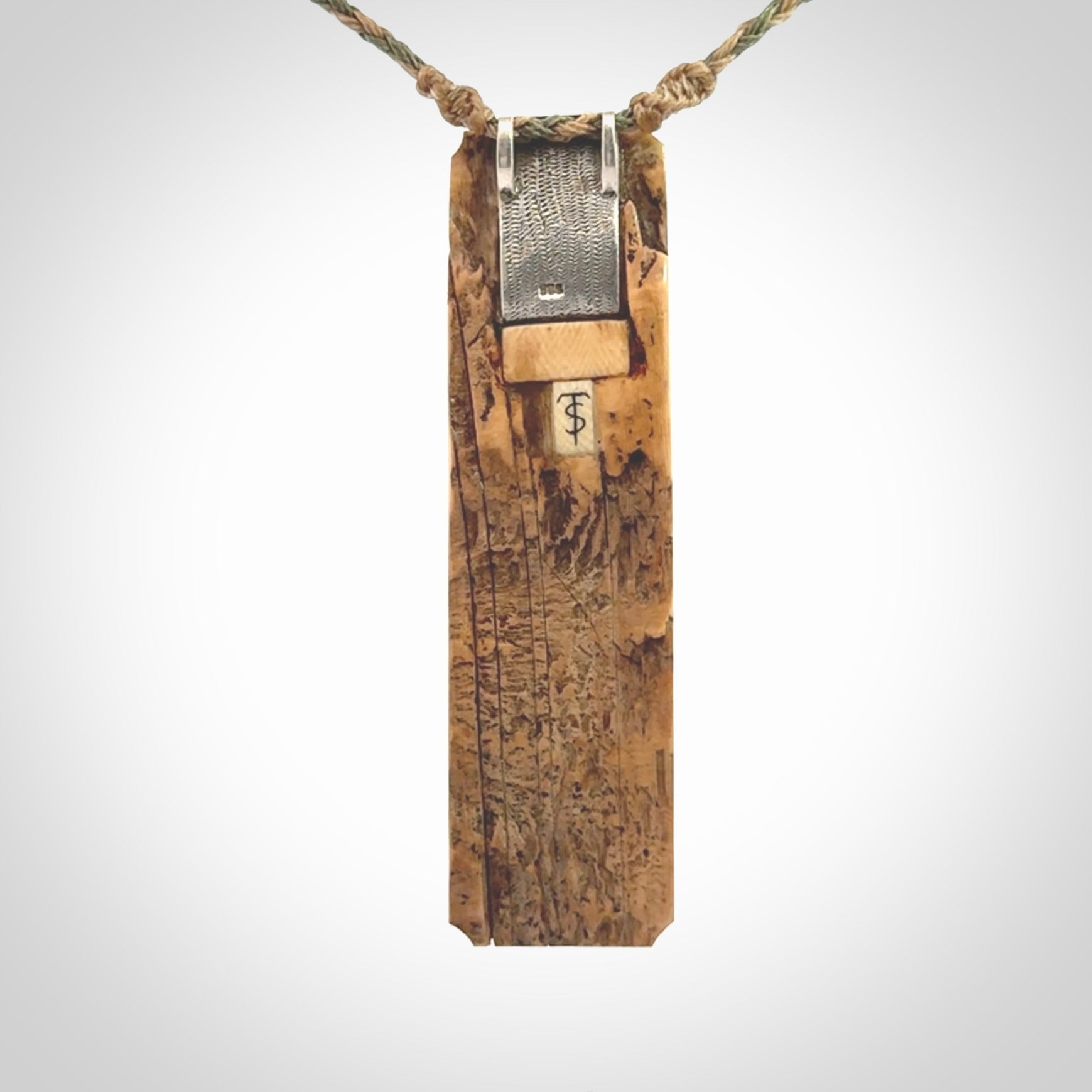 A beautiful, large toki with manaia pendant handmade from woolly mammoth tusk with Jade insert.