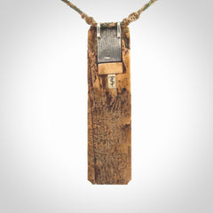 A beautiful, large toki with manaia pendant handmade from woolly mammoth tusk with Jade insert.