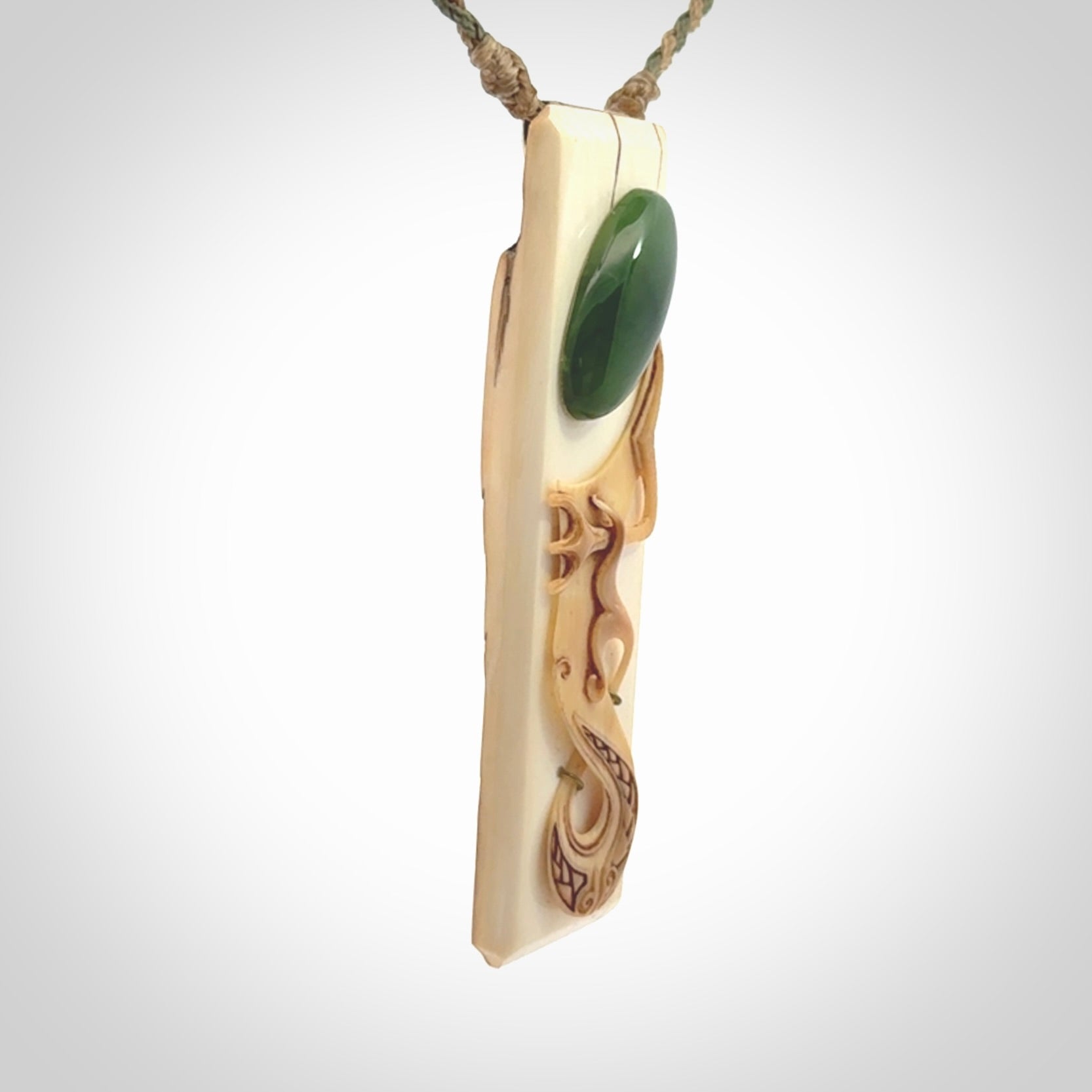 A beautiful, large toki with manaia pendant handmade from woolly mammoth tusk with Jade insert.