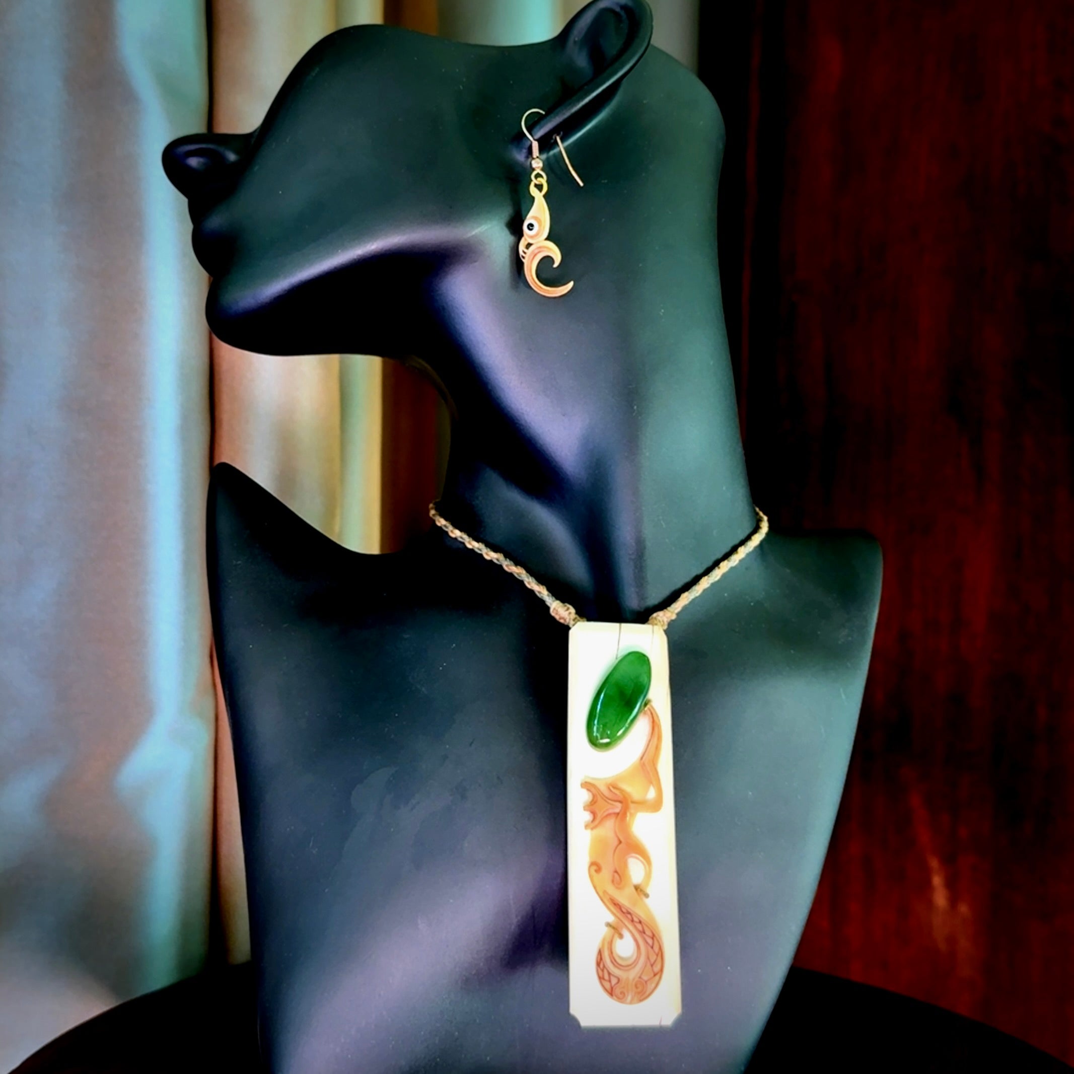 A beautiful, large woolly mammoth tusk with Jade insert toki pendant and woolly mammoth tusk earring.