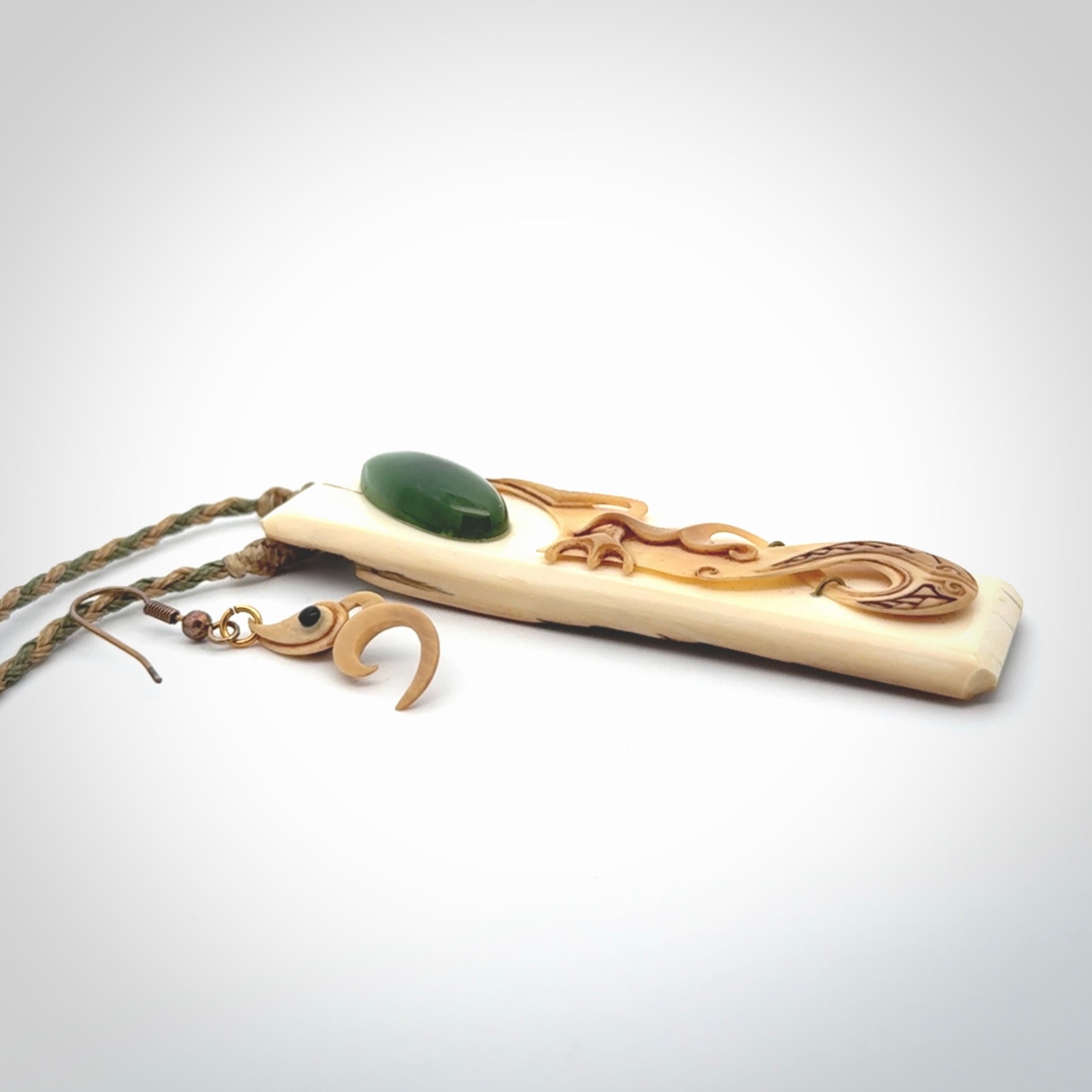 A beautiful, large woolly mammoth tusk with Jade insert toki pendant and woolly mammoth tusk earring.
